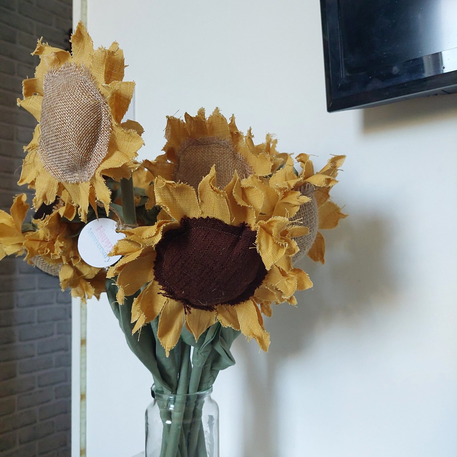 Close detail of a handmade yellow linen sunflower